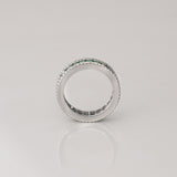 A timeless eternity band showcasing vivid channel-set emeralds, framed by brilliant round diamonds for an elegant statement of everlasting luxury.(PGDR0510)