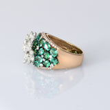 Featuring a sparkling diamond flower centerpiece surrounded by rich green emeralds, this ring is a true symbol of refined elegance. (PGDR0516)