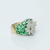 Featuring a sparkling diamond flower centerpiece surrounded by rich green emeralds, this ring is a true symbol of refined elegance. (PGDR0516)