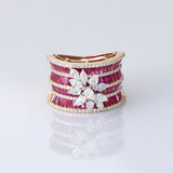 Layers of radiant rubies framed with shimmering diamonds, crowned by a floral diamond motif—pure elegance in every detail. (PGDR0517)