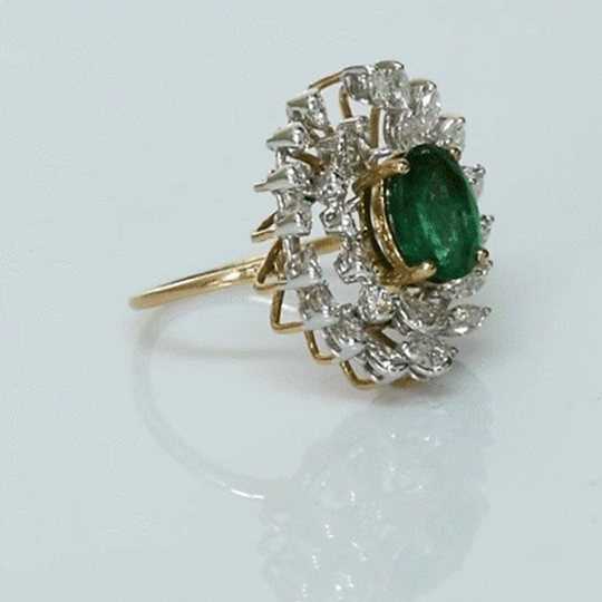 A vibrant emerald centerpiece surrounded by sparkling diamonds, creating a graceful ring filled with timeless elegance and charm.(PGDR0520)