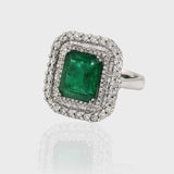 Ring, a dazzling fusion of timeless elegance and natural allure, featuring a captivating Colombian Emerald embraced by sparkling diamonds.(PGDR063)
