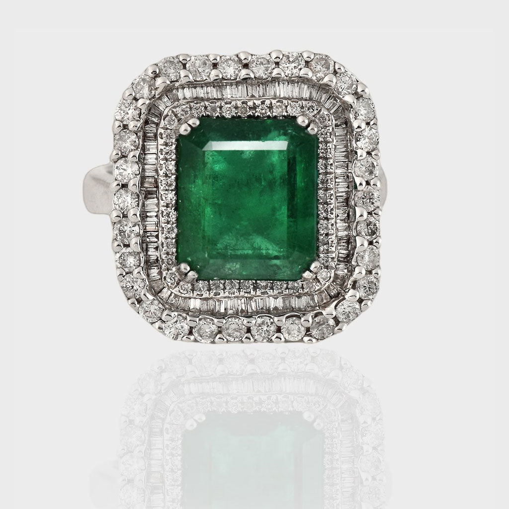 Ring, a dazzling fusion of timeless elegance and natural allure, featuring a captivating Colombian Emerald embraced by sparkling diamonds.(PGDR063)