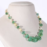 Exquisite carved Colombian emeralds paired with lustrous South Sea pearls, meticulously strung in gold wire to create refined timeless beauty.(STRG290)