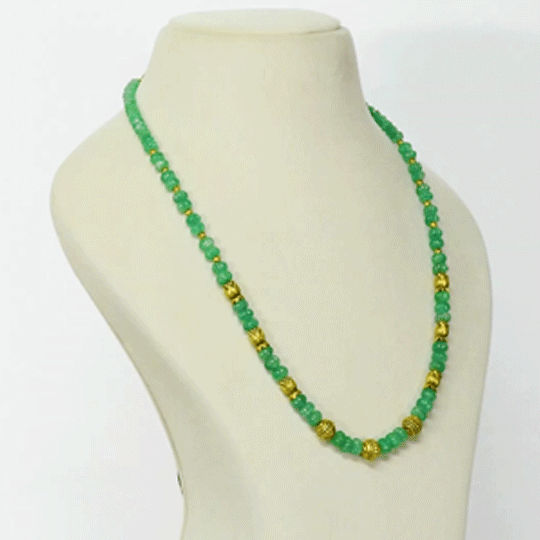 A refined string of intricately carved emerald beads accented with ornate gold beads, blending heritage artistry with enduring elegance and sophistication.(STRG378)
