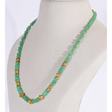 A refined string of intricately carved emerald beads accented with ornate gold beads, blending heritage artistry with enduring elegance and sophistication.(STRG378)