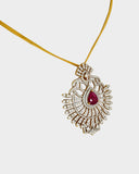 A stunning pendant with a vibrant pear ruby and round diamonds, offering classic elegance and luxurious, eye-catching charm.(WDN749)